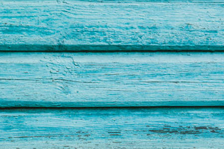 Blue plaque-wall of the old barn. Textured and peeling blue paint from old farm building. Background, texture.の写真素材