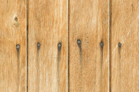 Yellow board with nails. The walls of the old barn. Textured and cleansing yellow paint from the old farm building.の写真素材