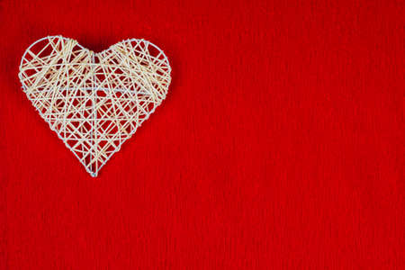 Woven heart on a red corrugated paper.の写真素材