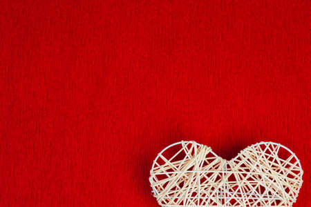 Woven heart on a red corrugated paper.の写真素材