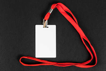 Empty card ID / icon with an orange belt on a black background. Space for text.の写真素材