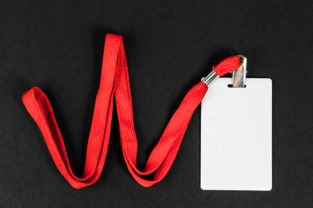 Empty card ID / icon with an orange belt on a black background. Space for text.の写真素材