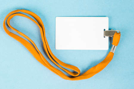 Empty ID card / icon with an orange belt, on a blue background. Space for text.の写真素材