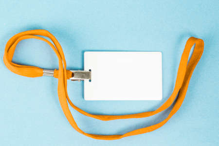 Empty ID card / icon with an orange belt, on a blue background. Space for text.の写真素材