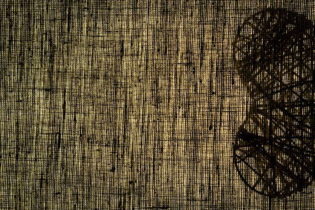 The shadow of a wicker heart on a linen canvas.の写真素材