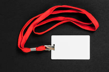 Empty card ID / icon with an orange belt on a black background. Space for text.の写真素材