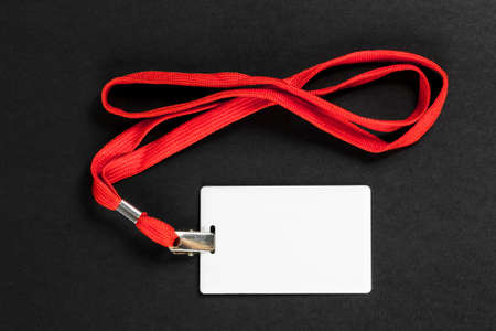 Empty card ID / icon with an orange belt on a black background. Space for text.の写真素材