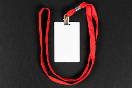Empty card ID / icon with an orange belt on a black background. Space for text.の写真素材