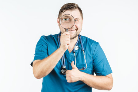 doctor using a magnifying glass on a white backgroundの写真素材
