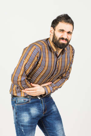 Man with abdominal pain. On a white background.の写真素材