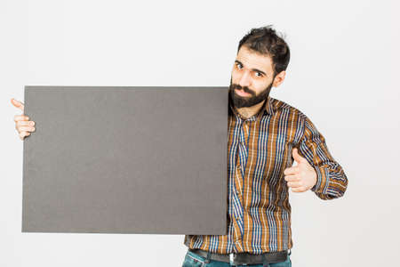 Portrait of a bearded businessman holding a black blank panel with space for text. Isolated on white...