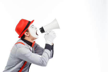 Clown, MIME, holding a Megaphone. The expression of emotions. On a white background.の写真素材