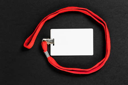 Empty card ID / icon with an orange belt on a black background. Space for text.の写真素材