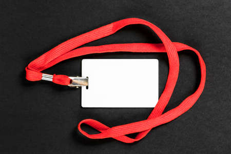 Empty card ID / icon with an orange belt on a black background. Space for text.の写真素材