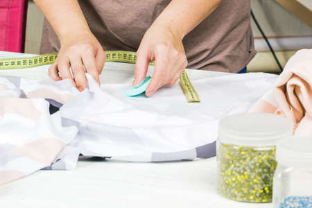 Fashionable design close-up. hands of the designer with chalk.