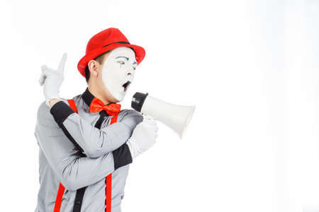Clown, MIME, holding a Megaphone. The expression of emotions. On a white background.の写真素材