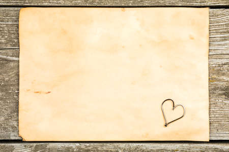 Fishing tackle - fishing, hooks, old sheet of paper on a wooden background.の写真素材