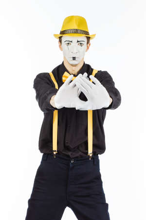 Portrait of a man, artist,clown, MIME. Shows the stop sign is forbidden. Isolated on white background.の写真素材
