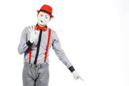 Portrait of a man, artist,clown, MIME. Shows something, isolated on white backgroundの写真素材