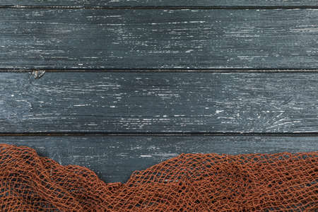 Wooden background with old fishing net