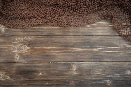 Wooden background with old fishing netの写真素材