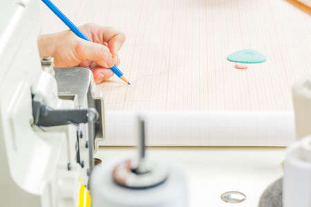 Tailors working with the measuring bar. leucalo.