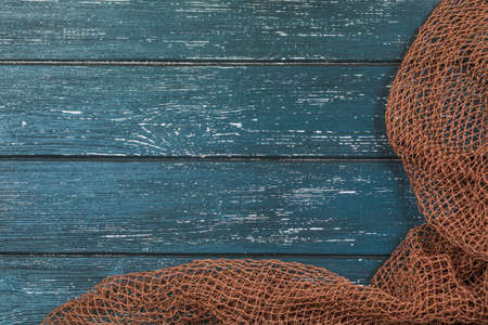 Wooden background with old fishing netの写真素材