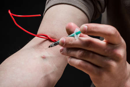Man vaccine injecting  in his arm. Drugs concept. Disease concept.  Drug addict man with syringe...