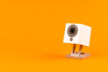 white webcam on orange background, object, Internet, technology concept.の写真素材