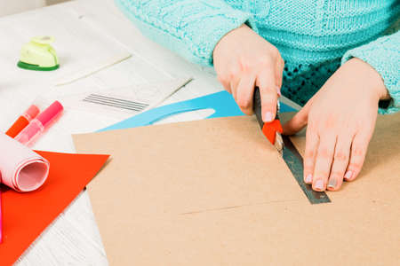 Handmade, the girl cuts out of paper. scrapbooking for a wedding or other holiday decorations. Tools...