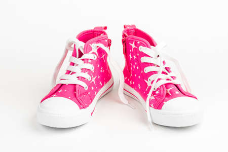 Red children's shoes. On white backgroundの写真素材