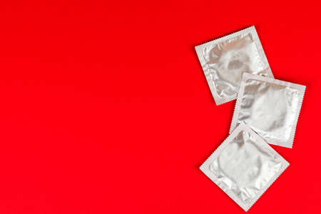 Condoms on an red background.の写真素材