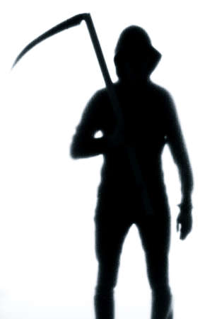 Dangerous man behind frosted glass with a scythe in his hand. Halloween. Black and white image