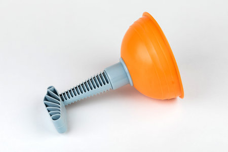 Plunger (plunger) orange for cleaning toilet on white background