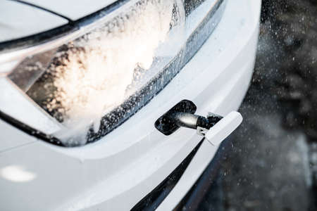 Headlight with a wiper detail on a car pollution. car wash.の写真素材