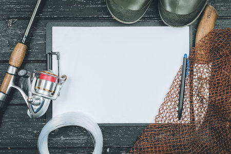 Fishing gear - fishing, fishing, hooks and baits, an old sheet of paper on a wooden background.