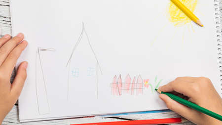Kids drawing and lots of pencils for drawing on wooden backgroundの写真素材