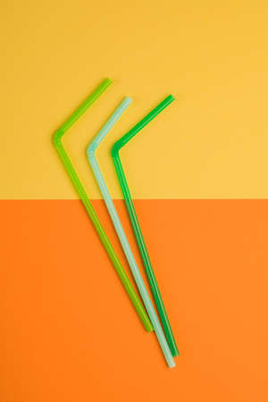 Drinking straws for colored background. Colorful plastic straws used for drinking water or soft drinksの写真素材