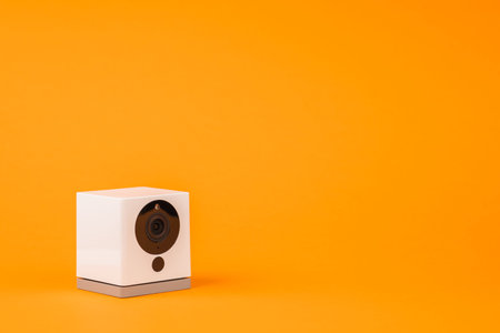 white webcam on orange background, object, Internet, technology concept.