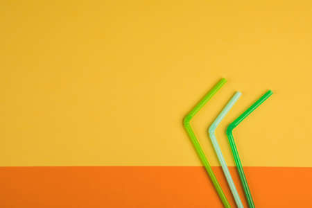 Drinking straws for colored background. Colorful plastic straws used for drinking water or soft drinksの写真素材