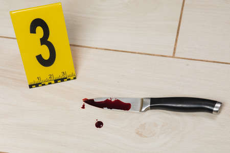 Crime scene investigation. Bloody knife. Evidence of murder.の写真素材