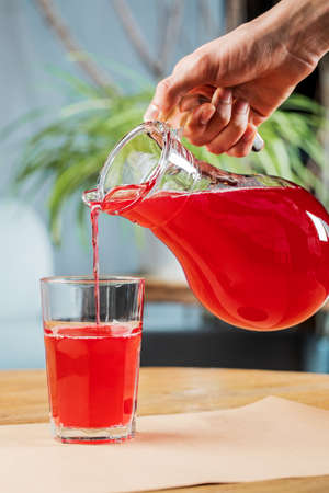 Fresh juice in a glass on a wooden table. The concept of healthy eating.の写真素材