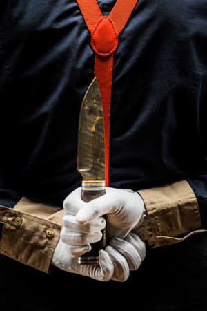 clown and Halloween theme: crazy clown with knife in hand isolated on dark background in Studioの写真素材