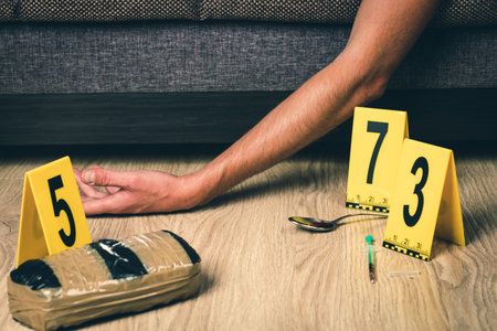 A man is a drug addict with a syringe using drugs lying on the floor. The concept of anti drugs. male drug addict, drug syringe.の写真素材