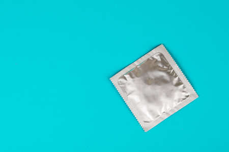 Condom on a blue background. The concept of safe sexの写真素材