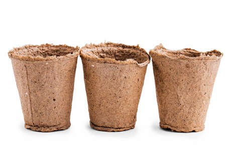 Pots for seedlings of ecological cardboard. Peat seed pots. Pots on isolated white background