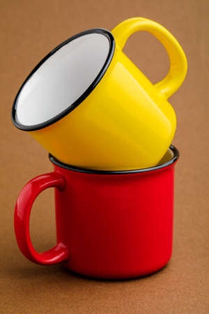 Red and yellow mug, on brown backgroundの写真素材