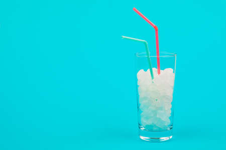 Glass of sugar. The concept of junk food. On red backgroundの写真素材