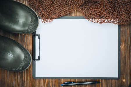 Fishing tackle-fishing, pen, hooks, wooden background.