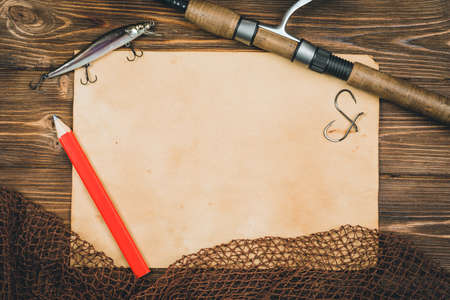 Fishing tackle-fishing, pen, hooks, wooden background.の写真素材